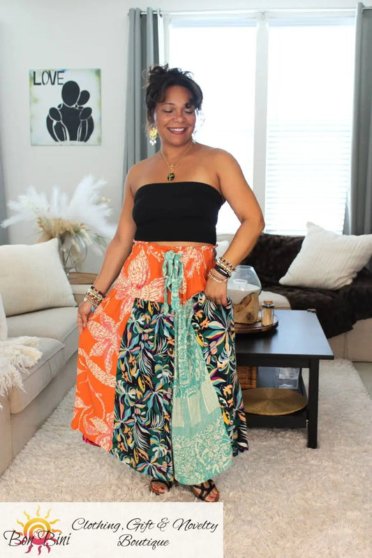Model in sandals holding unique bohemian wrap skirt.