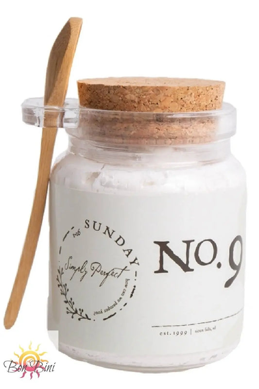Glass jar with cork lid and wooden spoon.