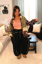 Load image into Gallery viewer, Model wearing a green/pink multi-color plaid shirt with it open to reveal a pink mauve tube top. Also wearing black jogger style pants with dark gray line accents.