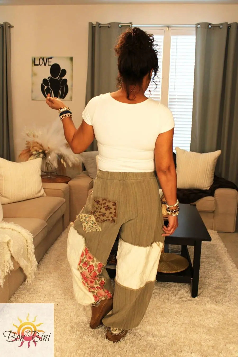Model showcasing the back of the pants and the back of the shirt.