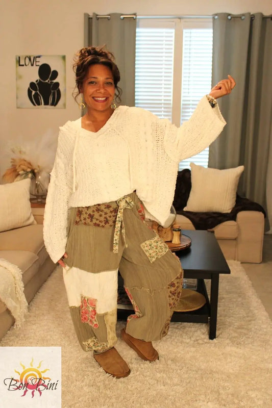 Model wearing a white cable knit texture cute sweater hoodie and olive green patchwork pants.
