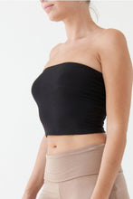 Load image into Gallery viewer, Black strapless top worn by a person on a white background