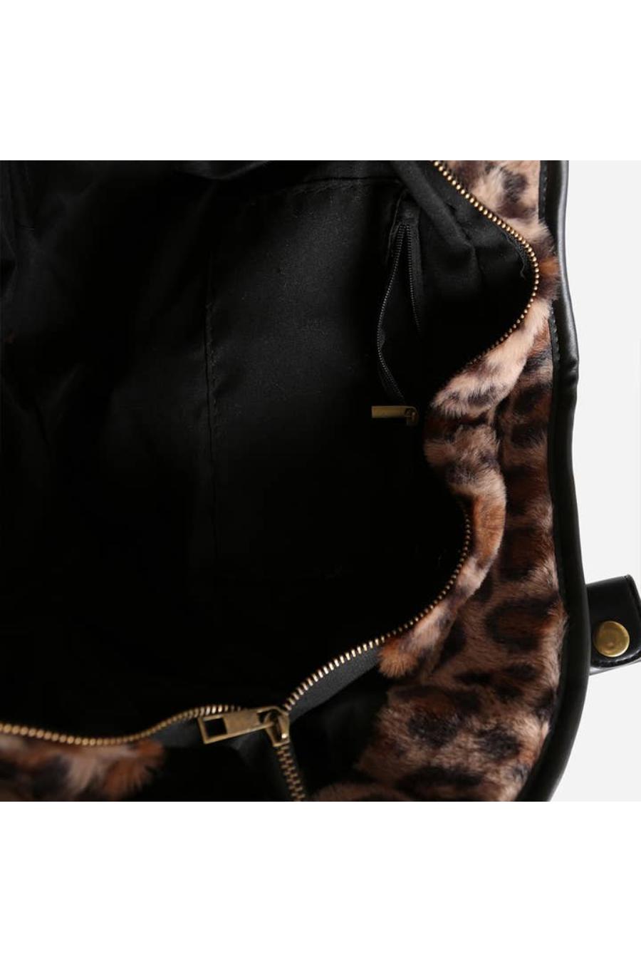 Black bag with leopard print interior and gold zipper.