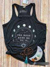 Load image into Gallery viewer, Incredibly dark grey (almost black) racerback tank with "The Moon Made Me Do It" text in white. Also features white moon phase design on front.