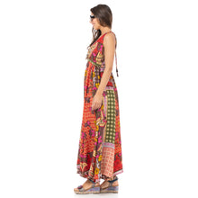 Load image into Gallery viewer, Side view of maxi dress showing red, orange, yellow, olive green, &amp; hot pink toned fabric print.
