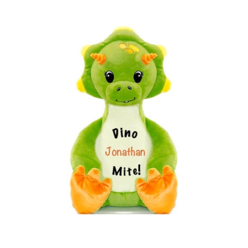 Light green triceratops dinosaur sitting upright with orange horns and feet pads, eyelashed eyes, baby tooth smile, 