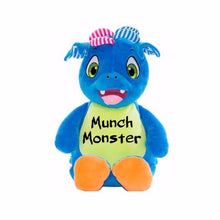 Load image into Gallery viewer, Blue stuffed patchwork dragon sitting upright with light green belly, orange feet pads, green eyes, and "Munch Monster" in black text across belly.