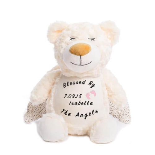 Cream colored teddy bear with shimmer wings, closed eyes, calm smile, and 
