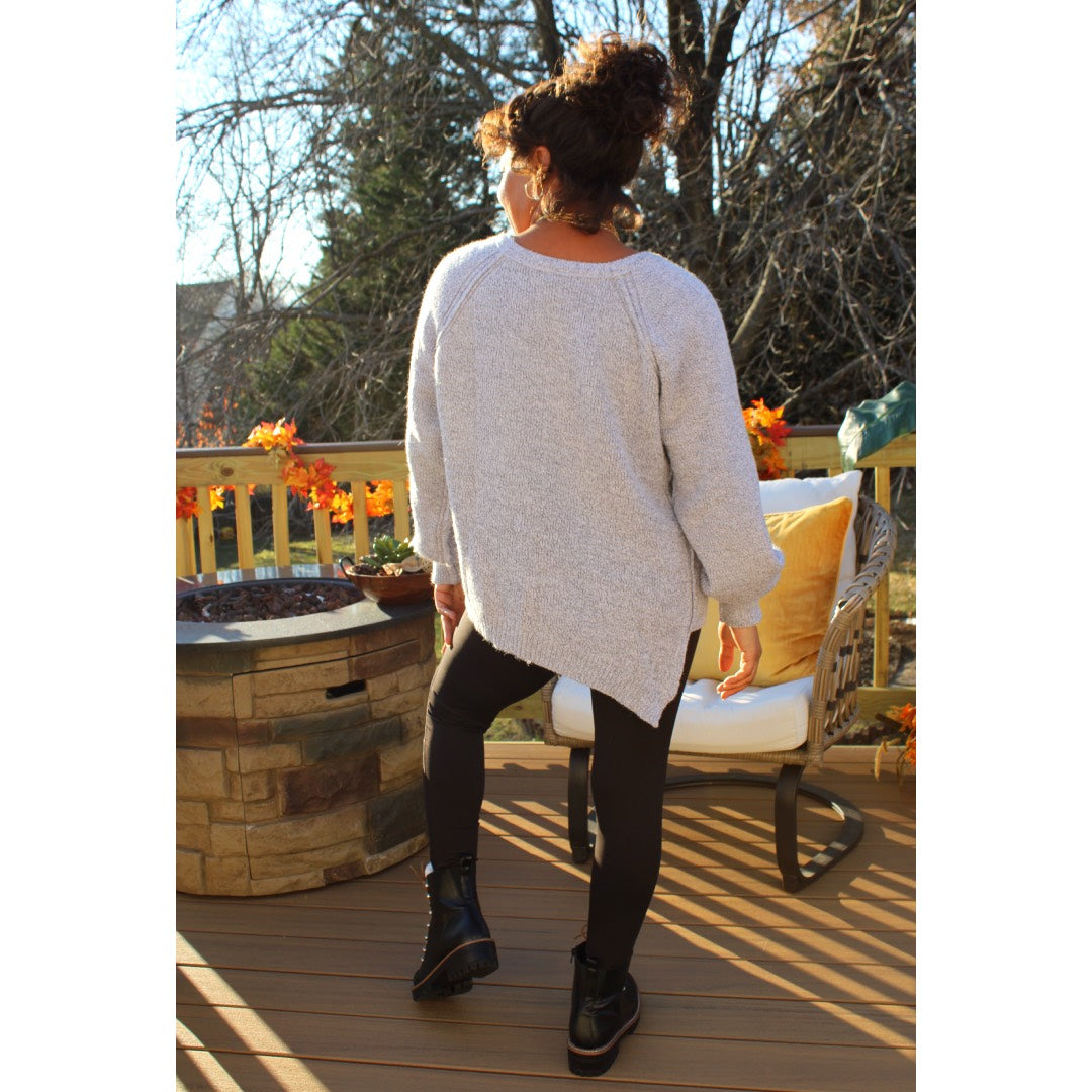 Back view of Lavender Gray sweater tunic with left side seam slit and black knee cut out leggings
