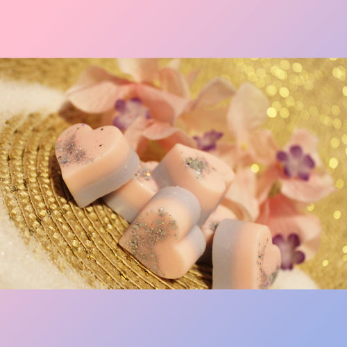 Lavender hear-shaped wax melts with light pink layer and silver glitter on top.