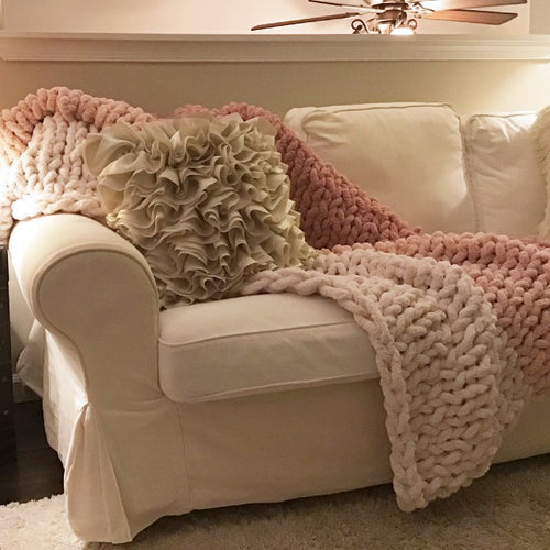 Cream, blush, & mauve ombre knit weave blanket laid out.