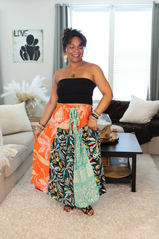 Model in sandals holding unique bohemian wrap skirt.