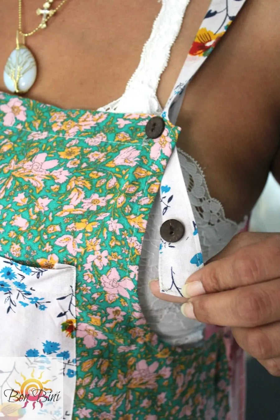 Rosa verde overall straps showing adjustable buttons.