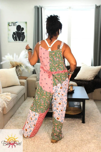 Model showing back of overall floral patchwork jumpsuit 