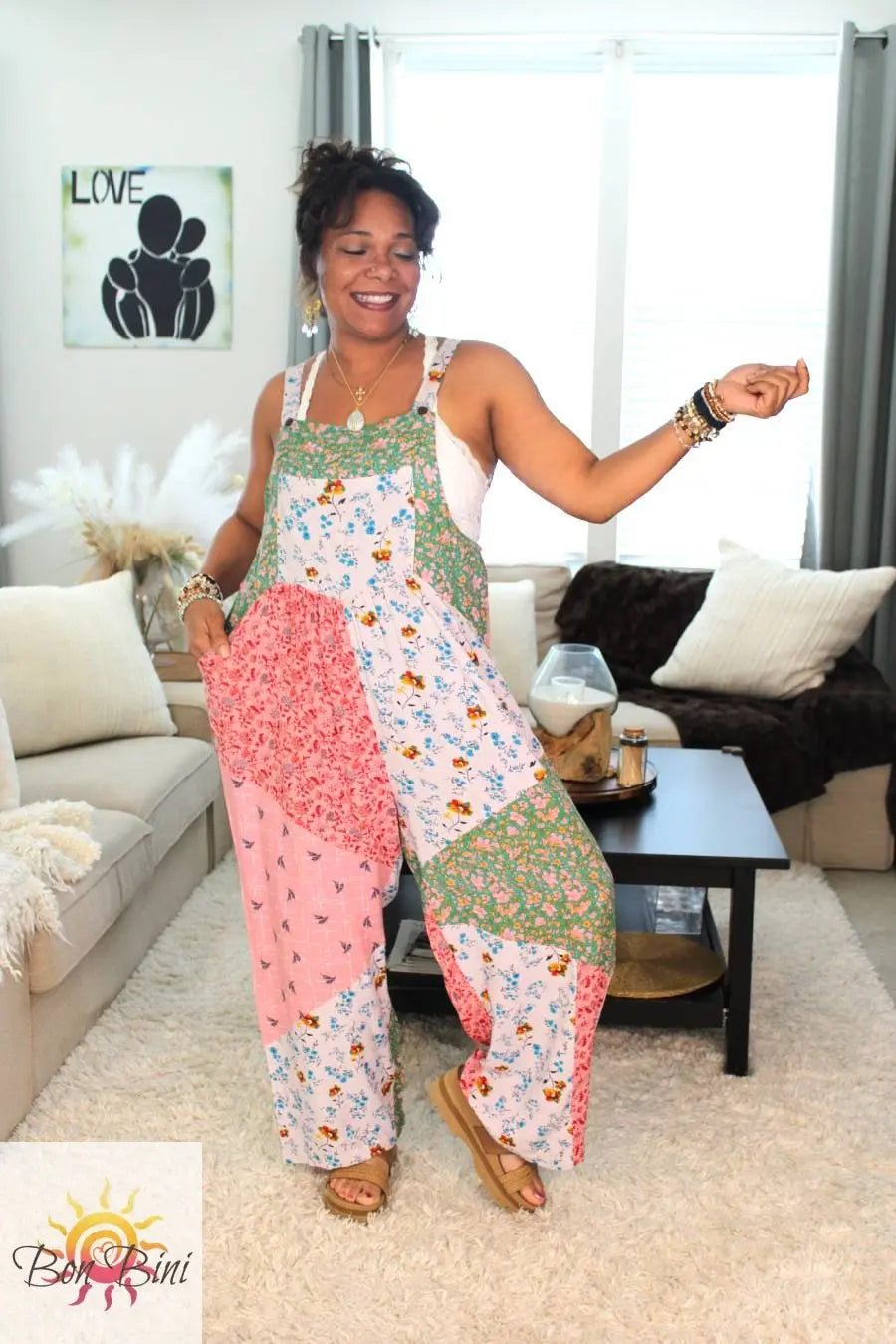 Model wearing a colorful patchwork floral overall.