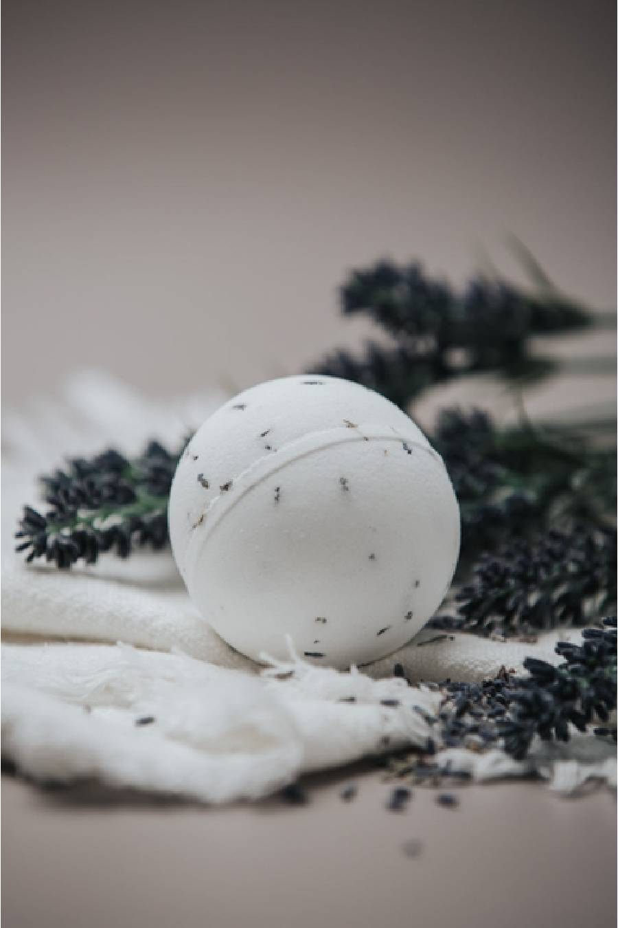 White bath bomb with black lavender flowers.