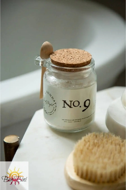 Jar labeled 'No. 9' with a cork lid and wooden spoon, on a counter.