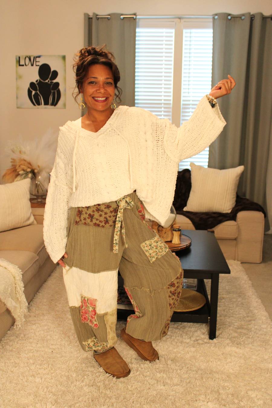 Model wearing a white cable knit texture cute sweater hoodie and olive green patchwork pants.