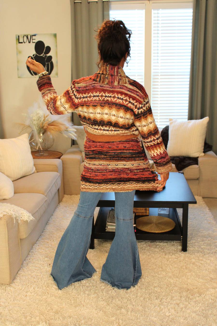Model showcasing the cardigan from the back again.