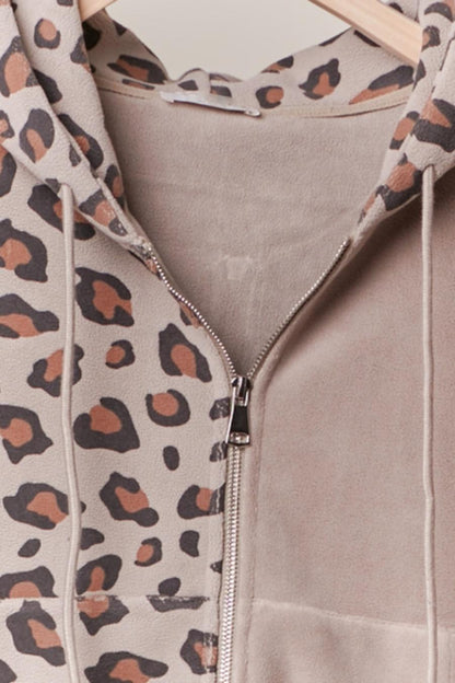 Leopard print hoodie with a zipper on a neutral background