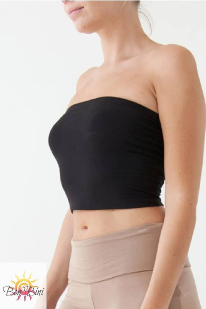 Black strapless top worn by a person on a white background