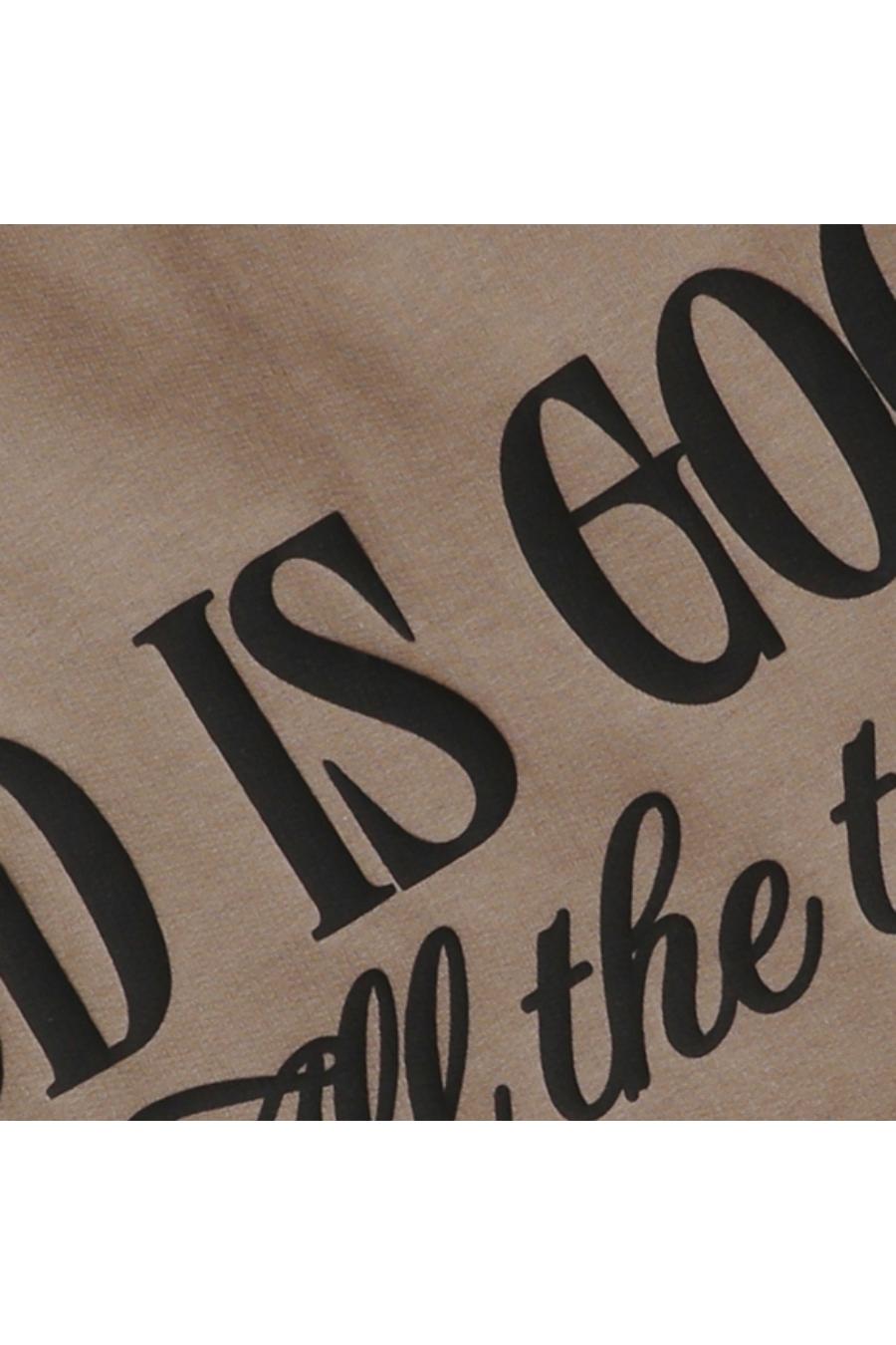 Close up of black "GOD IS GOOD All the time" text on brown sweatshirt.