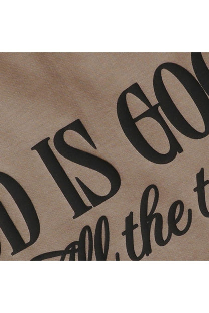Close up of black "GOD IS GOOD All the time" text on brown sweatshirt.