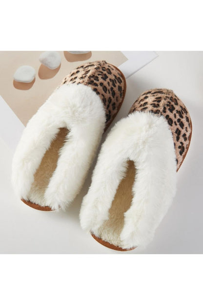 Pair of slippers with white fur lining and leopard print.