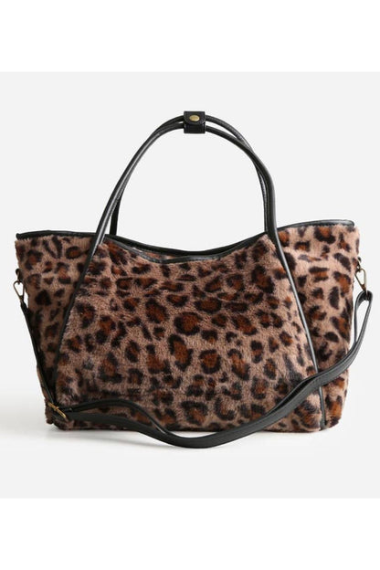 Leopard print handbag with black handles and strap.