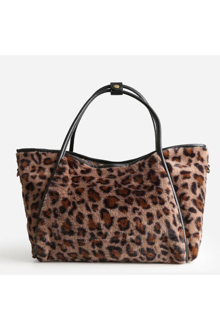 Leopard print handbag with black handle.