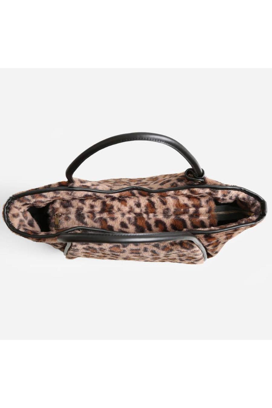 Leopard print handbag with black handles.