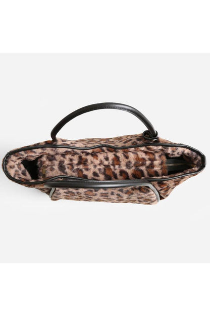Leopard print handbag with black handles.