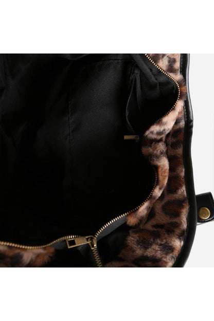 Black bag with leopard print interior and gold zipper.
