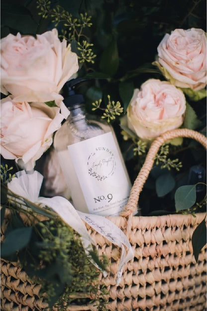 A clear pump bottle of No. 9 body wash with a white label that includes the product name and a brief description.