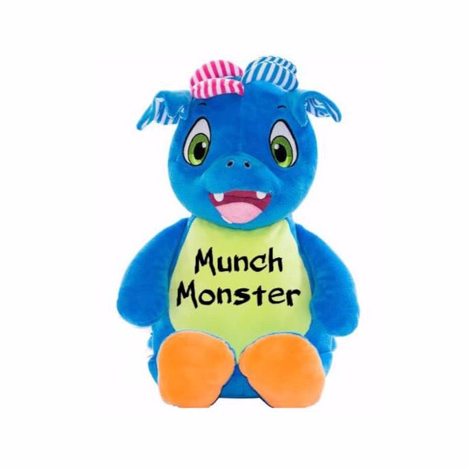 Blue stuffed patchwork dragon sitting upright with light green belly, orange feet pads, green eyes, and "Munch Monster" in black text across belly.