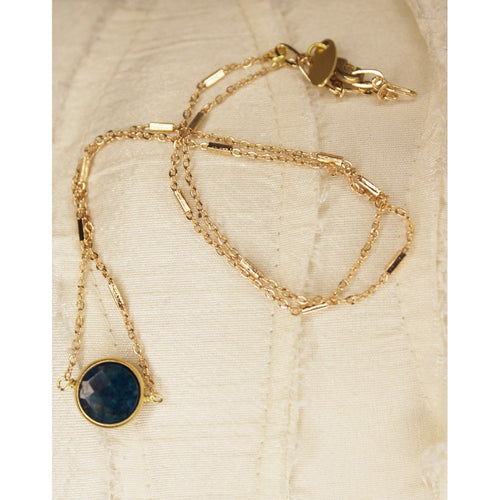 Teal apatite small circle stone in gold circle set.