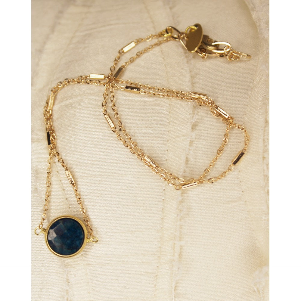 Teal apatite small circle stone in gold circle set.