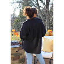 Load image into Gallery viewer, back view of black fleece shacket showing elbow patches and light wash jeans
