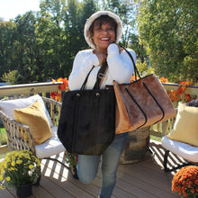 Load image into Gallery viewer, Model showing brown velvet &amp; black velvet versions of tote bag.
