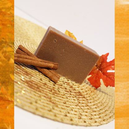 Brown colored soap bar next to cinnamon sticks.
