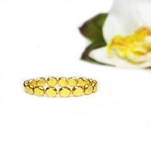 Load image into Gallery viewer, One gold ring made out of many small gold disks strung on gold wire to form ring shape.
