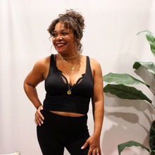 Load image into Gallery viewer, front view of black surpliced ribbed crop top with black flared yoga pants and layered necklaces
