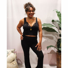 Load image into Gallery viewer, front view of black surpliced ribbed crop top with black flared yoga pants and layered necklaces
