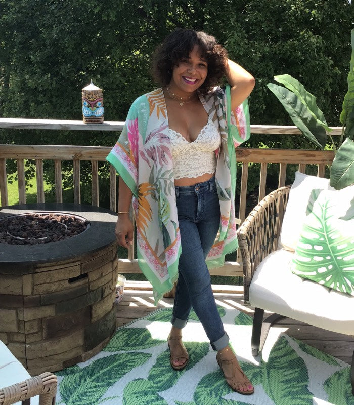 Off-white kimono with light pink, hot pink, orange, & mint green palms fronds design. Features mint green border.